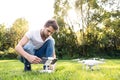 Young hipster man with drone. Sunny green nature. Royalty Free Stock Photo