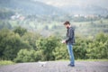 Young hipster man with flying drone. Sunny green nature. Royalty Free Stock Photo