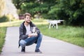 Young hipster man with flying drone. Sunny green nature. Royalty Free Stock Photo