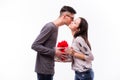 Young hipster Man Giving a Gift on holiday and kiss his girlfriend. Royalty Free Stock Photo