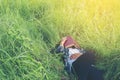 Young hipster man lying down on grassland napping tired after re