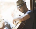 Young hipster man plays the guitar Royalty Free Stock Photo