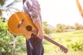 Young hipster man practiced guitar in the park,happy and enjoy playing guitar.