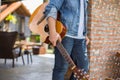 Young hipster man practiced guitar in the park,happy and enjoy playing guitar.