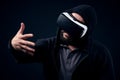 Young hipster man wearing virtual reality goggles. Black background studio VR concept Royalty Free Stock Photo