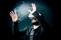 Young hipster man wearing virtual reality goggles. Black background studio VR concept Royalty Free Stock Photo