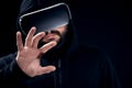 Young hipster man wearing virtual reality goggles. Black background studio VR concept Royalty Free Stock Photo