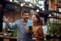 Young hipster man and woman in the bar having a great time and talking Royalty Free Stock Photo