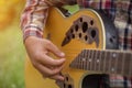 Young hipster man and woman playing guitar to relaxing on his holiday