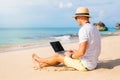 Young man working with laptop computer on the beach Royalty Free Stock Photo