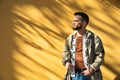 Young hipster millennial man standing on the street waiting for woman he met online on online dating site or social network. Royalty Free Stock Photo