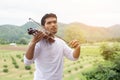 Young hipster musician man playing violin in the nature outdoor lifestyle behind mountain