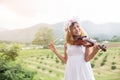 Young hipster musician woman playing violin in the nature outdoor lifestyle behind mountain Royalty Free Stock Photo