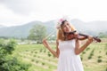 Young hipster musician woman playing violin in the nature outdoor lifestyle behind mountain Royalty Free Stock Photo