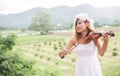 Young hipster musician woman playing violin in the nature outdoor lifestyle behind mountain Royalty Free Stock Photo