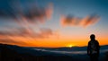 Young hipster photographer holding the camera with sunset on mountain natural background Royalty Free Stock Photo