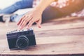 Young hipster photographer woman taking photo and look at camera sitting on wooden floor Royalty Free Stock Photo