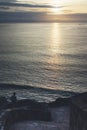 Young hipster relax on the beach on background ocean sunrise, silhouette romantic person looking view evening seascape, girl enjoy Royalty Free Stock Photo