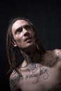 Young hipster with tattoo. Portrait of modern guy with dreadlocks. Royalty Free Stock Photo