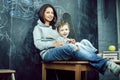 Young hipster teenage girl sitting with her little brother in classroom multinational, lifestyle people concept Royalty Free Stock Photo