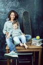 Young hipster teenage girl sitting with her little brother in classroom multinational, lifestyle people concept Royalty Free Stock Photo