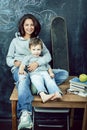 Young hipster teenage girl sitting with her little brother in classroom multinational, lifestyle people concept Royalty Free Stock Photo