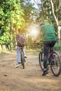 Young Hipster tourist riding bicycles in the forest back to camera, Couple mountain biking to the forest trail, back view Royalty Free Stock Photo