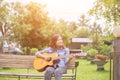 Close up of young hipster woman practiced guitar in the park,happy and enjoy playing guitar Royalty Free Stock Photo