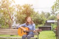 Close up of young hipster woman practiced guitar in the park,happy and enjoy playing guitar Royalty Free Stock Photo