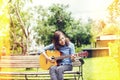 Close up of young hipster woman practiced guitar in the park,happy and enjoy playing guitar Royalty Free Stock Photo