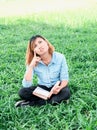 Young hipster woman reading a book has an idea pointing with fin Royalty Free Stock Photo