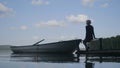 Young hipster woman sitting on wooden pier, Relaxing. Young blonde woman sitting on a wooden jetty on a lake Royalty Free Stock Photo