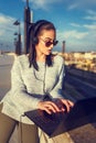 Young hipster woman typing on laptop outdoor Royalty Free Stock Photo