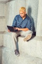 Young Hispanic American Man working on small computer outside Royalty Free Stock Photo