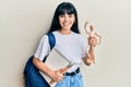 Young hispanic art student girl holding wooden manikin and notebook smiling and laughing hard out loud because funny crazy joke Royalty Free Stock Photo