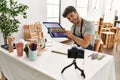 Young hispanic artist man smiling happy making online paint class at art studio Royalty Free Stock Photo