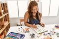 Young hispanic artist woman smiling happy drawing at art studio Royalty Free Stock Photo