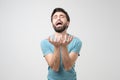 Young hispanic bearded man looking desperate and frustrated, stressed, unhappy