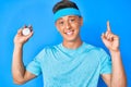 Young hispanic boy holding stopwatch surprised with an idea or question pointing finger with happy face, number one Royalty Free Stock Photo