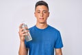 Young hispanic boy using hand sanitizer gel thinking attitude and sober expression looking self confident Royalty Free Stock Photo