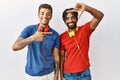 Young hispanic brothers standing over isolated background wearing headphones smiling making frame with hands and fingers with Royalty Free Stock Photo