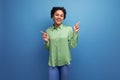 young hispanic brunette lady dressed in a green stylish shirt against the background with copy space