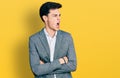 Young hispanic business man with arms crossed gesture angry and mad screaming frustrated and furious, shouting with anger Royalty Free Stock Photo