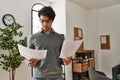 Young hispanic businessman concentrate reading paperworks at the office Royalty Free Stock Photo