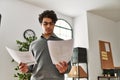 Young hispanic businessman concentrate reading paperworks at the office Royalty Free Stock Photo