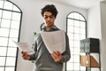 Young hispanic businessman concentrate reading paperworks at the office Royalty Free Stock Photo