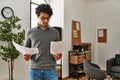 Young hispanic businessman concentrate reading paperworks at the office Royalty Free Stock Photo