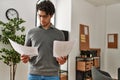 Young hispanic businessman concentrate reading paperworks at the office Royalty Free Stock Photo