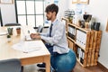 Young hispanic businessman sitting on fit ball working at the office Royalty Free Stock Photo