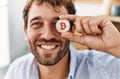 Young hispanic businessman smiling happy holding bitcoin over eye at the office Royalty Free Stock Photo